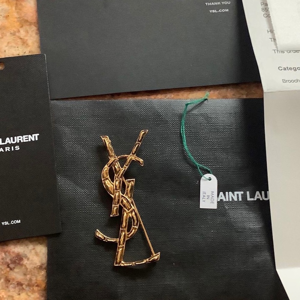 SOLD.  YSL Brooch brand new in box with receipt.